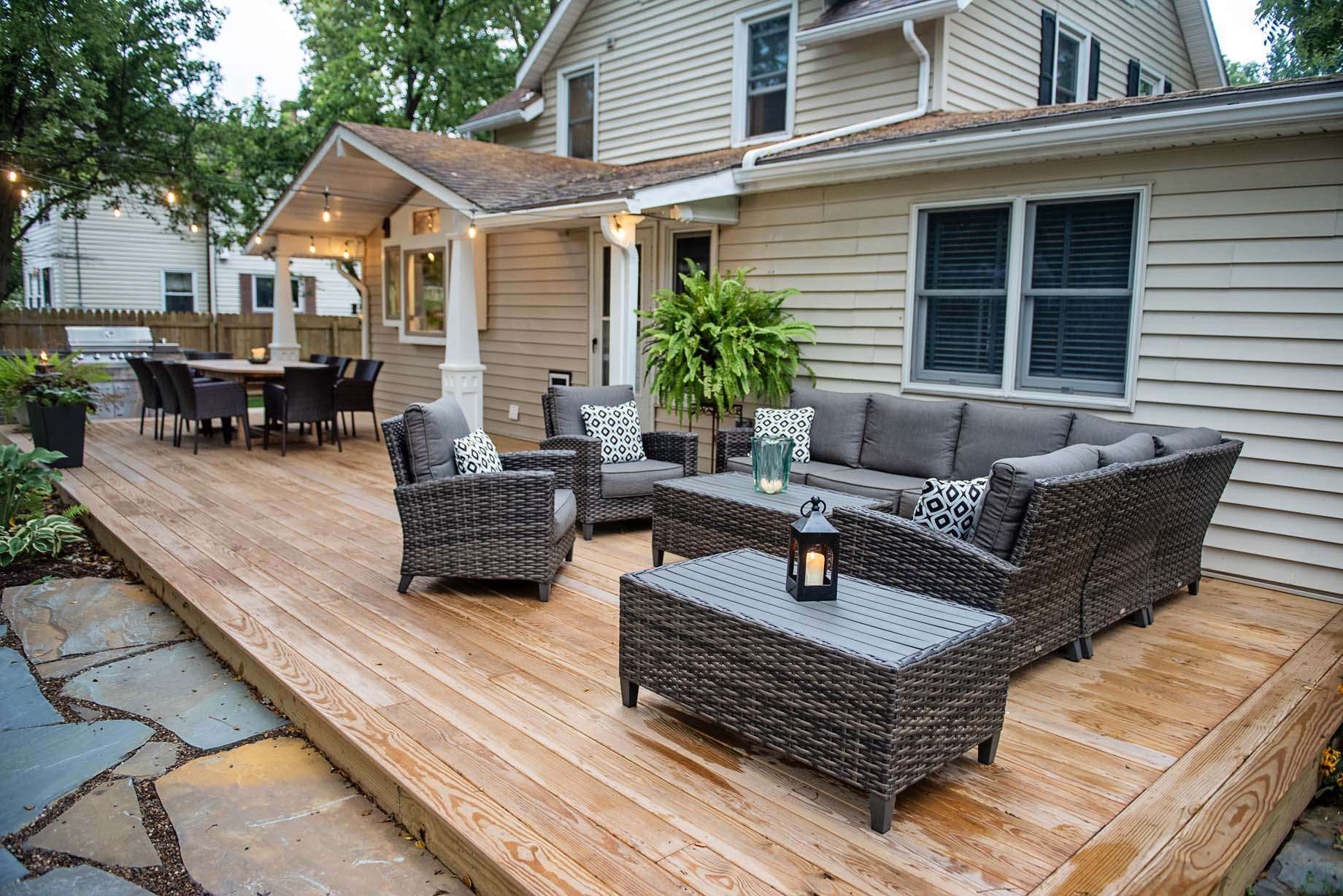 A newly installed deck and porch with a bunch of chairs